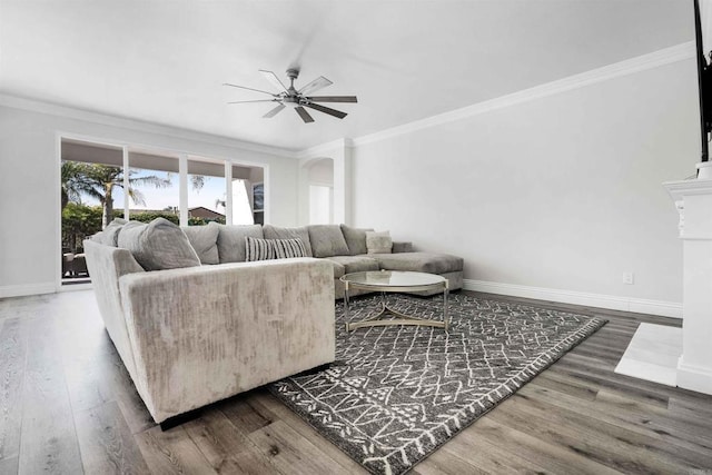 living room featuring ceiling fan, crown molding, and wood-type flooring