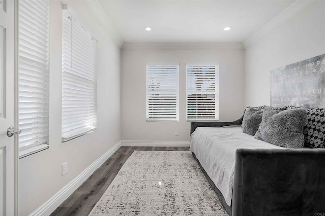 bedroom with multiple windows, dark hardwood / wood-style floors, and crown molding