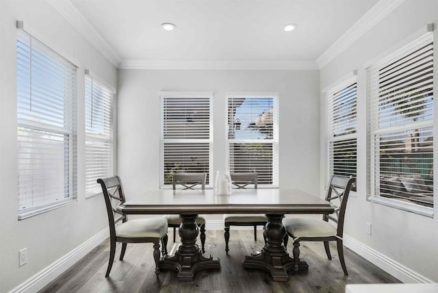 dining area featuring a healthy amount of sunlight, crown molding, and hardwood / wood-style flooring