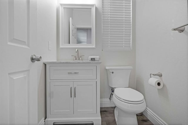 bathroom featuring toilet and vanity