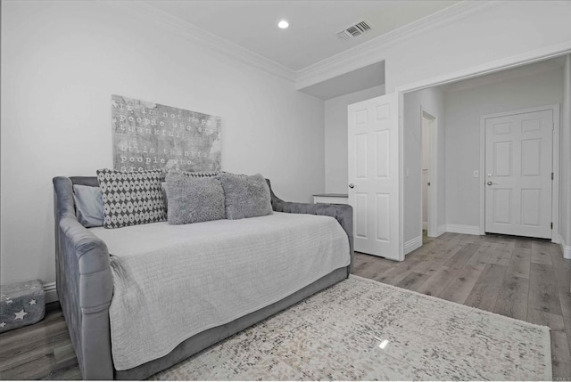 bedroom featuring wood-type flooring and crown molding