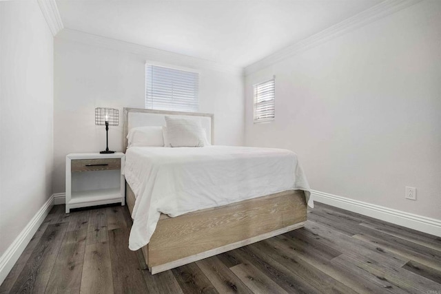 bedroom with dark hardwood / wood-style flooring and ornamental molding