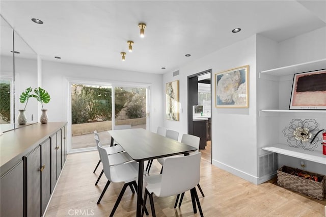 dining space with light hardwood / wood-style flooring