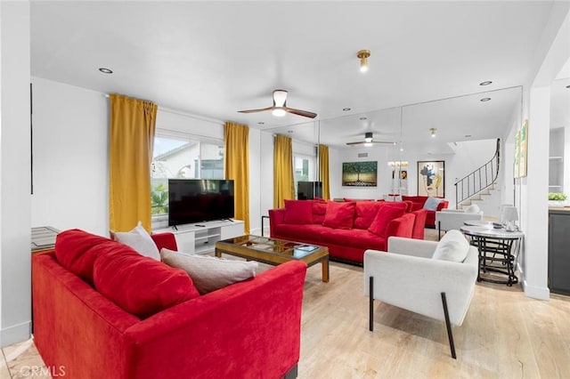 living room featuring light hardwood / wood-style floors and ceiling fan