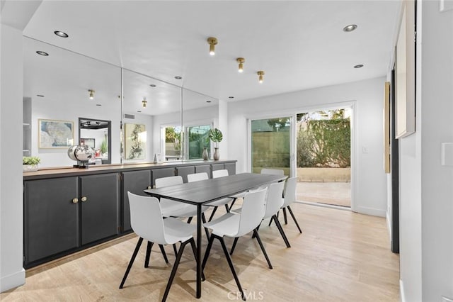 dining area featuring light hardwood / wood-style floors and a healthy amount of sunlight