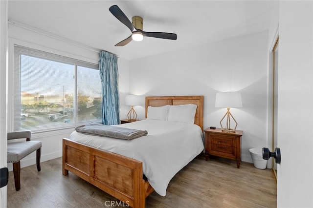 bedroom with ceiling fan and wood-type flooring