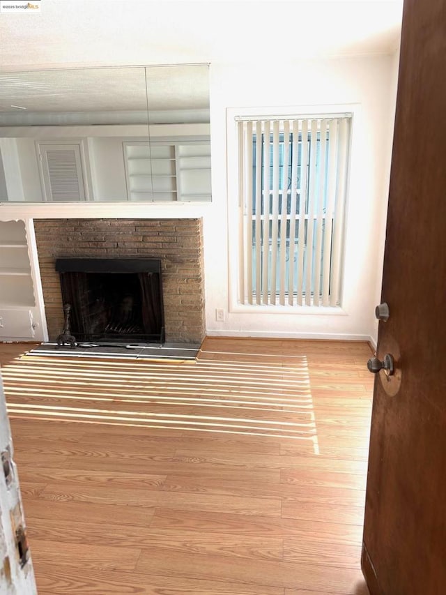 unfurnished living room featuring hardwood / wood-style flooring