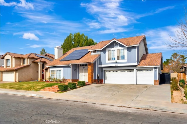 front of property with solar panels and a garage