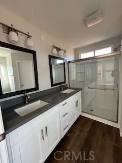 bathroom featuring vanity, hardwood / wood-style floors, and walk in shower