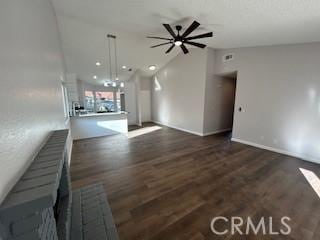 unfurnished living room featuring ceiling fan, dark hardwood / wood-style flooring, and vaulted ceiling