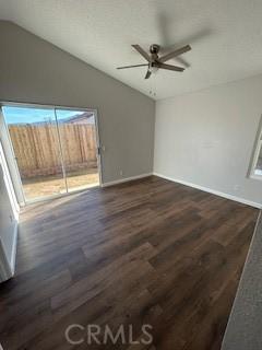 empty room featuring lofted ceiling, ceiling fan, and dark hardwood / wood-style flooring