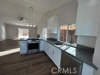 kitchen featuring white cabinets, kitchen peninsula, sink, and stainless steel stove