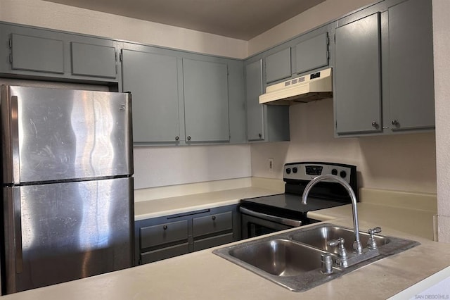 kitchen featuring appliances with stainless steel finishes, sink, and gray cabinets