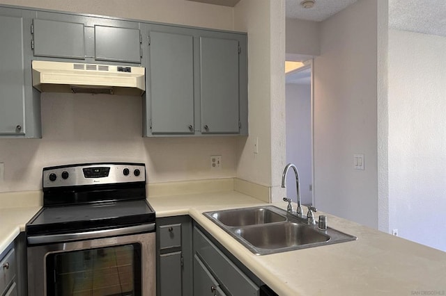 kitchen featuring electric stove, sink, and gray cabinetry