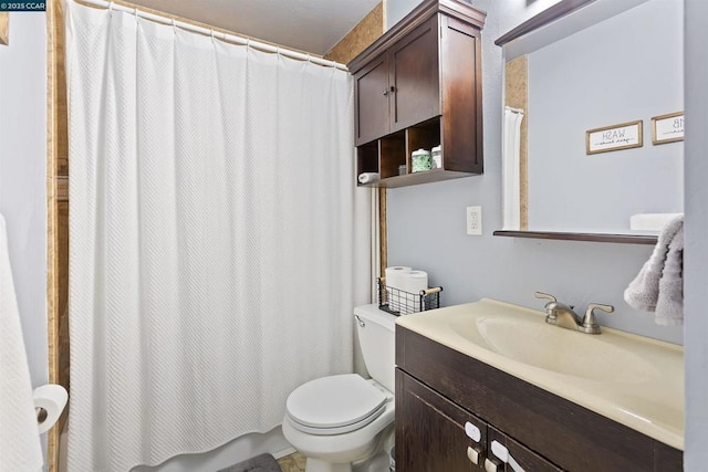 bathroom with toilet, vanity, and curtained shower