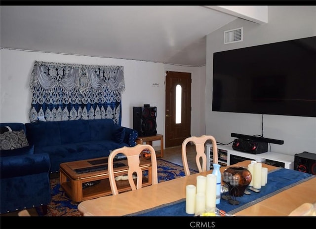 living room featuring lofted ceiling