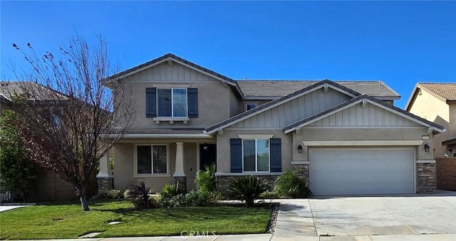 craftsman-style home featuring a front lawn and a garage