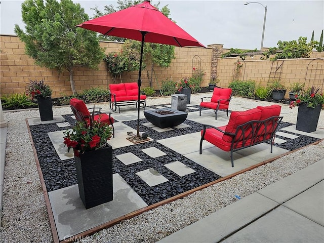 view of patio / terrace featuring an outdoor living space with a fire pit