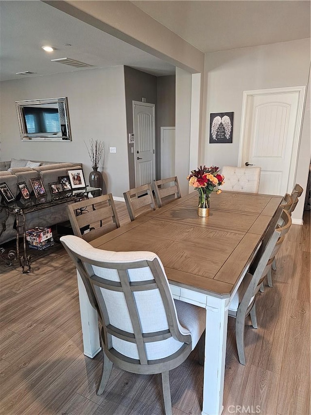 dining space with hardwood / wood-style flooring