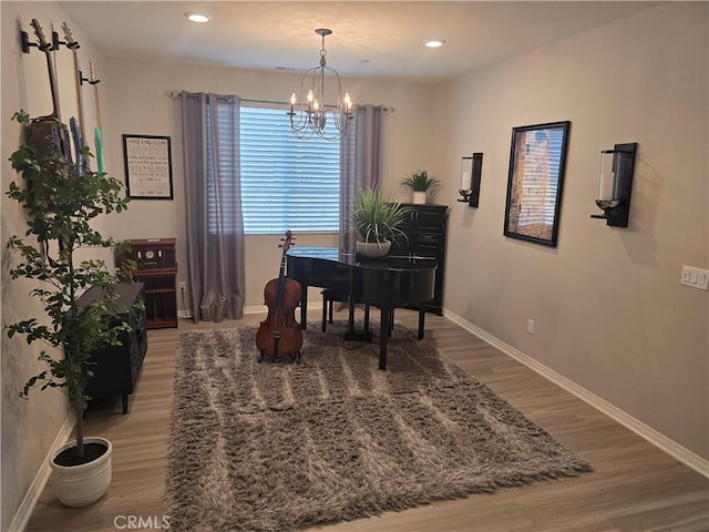 dining area featuring hardwood / wood-style floors and a chandelier