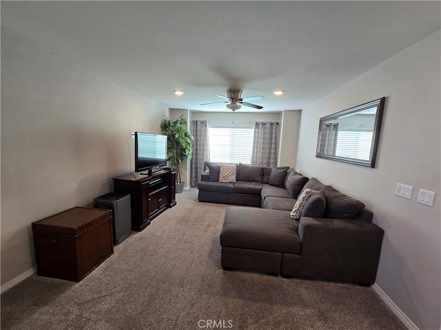 carpeted living room featuring ceiling fan