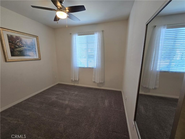 carpeted empty room featuring ceiling fan