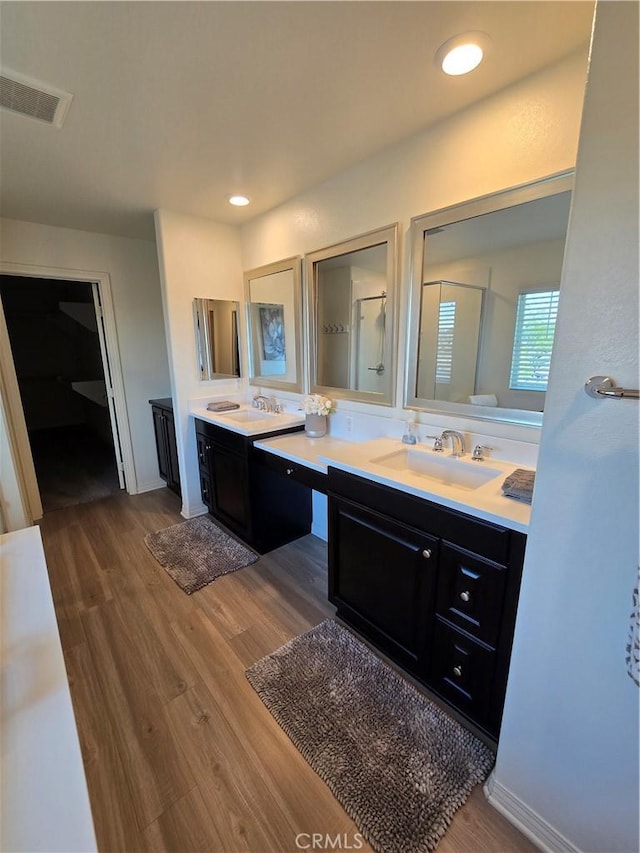 bathroom featuring vanity, a shower with door, and hardwood / wood-style floors