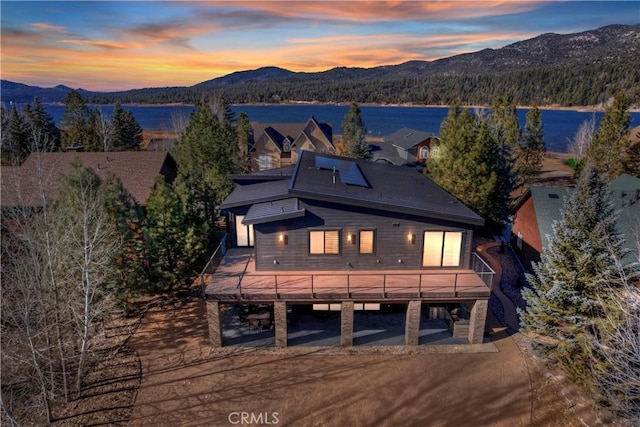 exterior space featuring a deck with water view