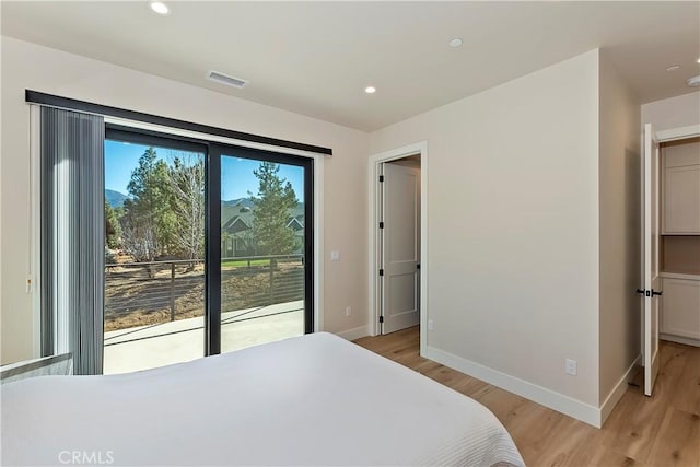 bedroom with light hardwood / wood-style floors and access to outside