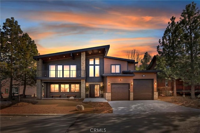 contemporary house with a balcony and a garage