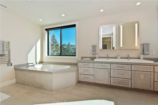 bathroom featuring tile patterned floors, radiator heating unit, a bathing tub, and vanity