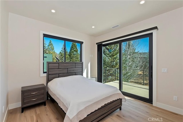 bedroom featuring light wood-type flooring and access to outside