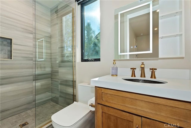 bathroom with toilet, vanity, and an enclosed shower