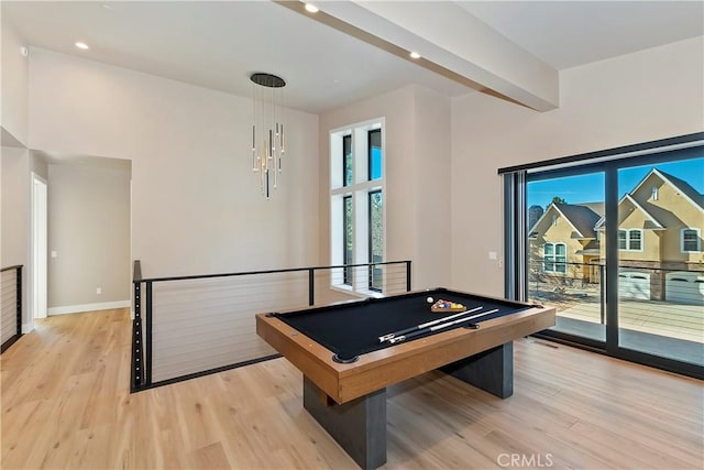 recreation room with pool table, light hardwood / wood-style flooring, and beam ceiling