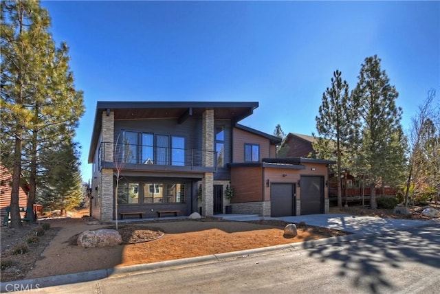 view of front of home featuring a garage and a balcony