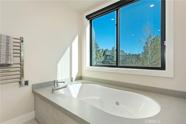 bathroom featuring radiator heating unit and a bathing tub