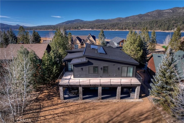 birds eye view of property with a water and mountain view