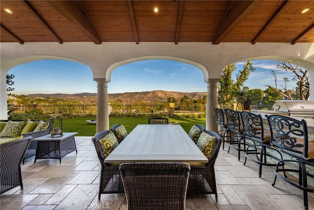 view of patio with a mountain view, area for grilling, and exterior kitchen