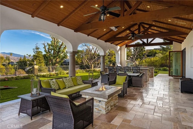 view of patio with a gazebo, a mountain view, ceiling fan, and an outdoor living space with a fire pit