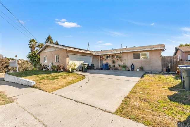 ranch-style house featuring stucco siding, driveway, fence, a front yard, and a garage