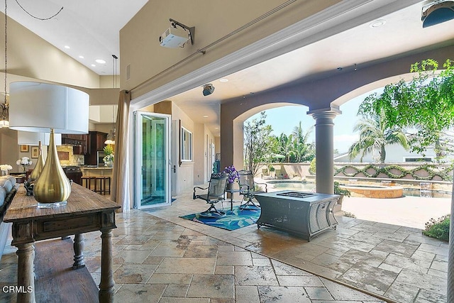 view of patio with a swimming pool with hot tub