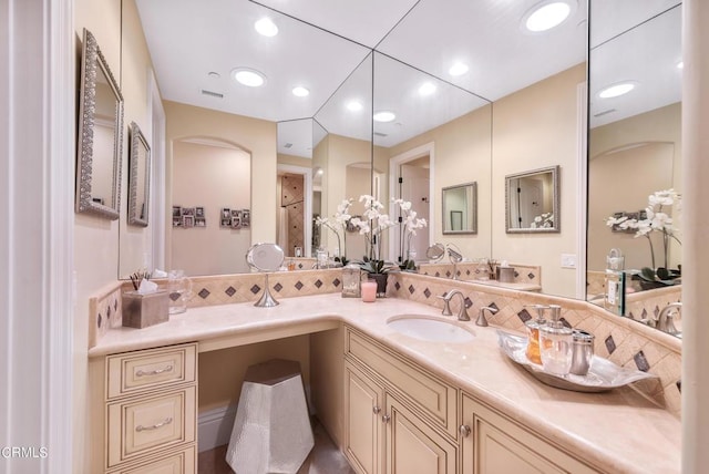 bathroom with walk in shower and vanity