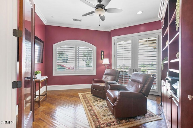 sitting room featuring ceiling fan, dark wood-type flooring, ornamental molding, and french doors