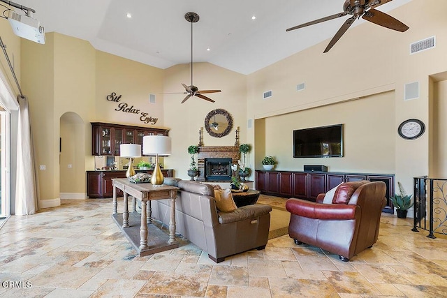 living room featuring high vaulted ceiling and ceiling fan