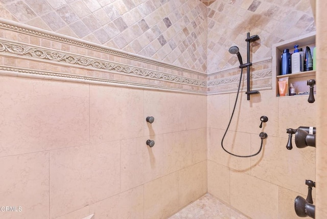 bathroom with a tile shower