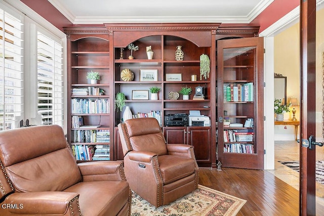 living area featuring dark hardwood / wood-style flooring, crown molding, and french doors