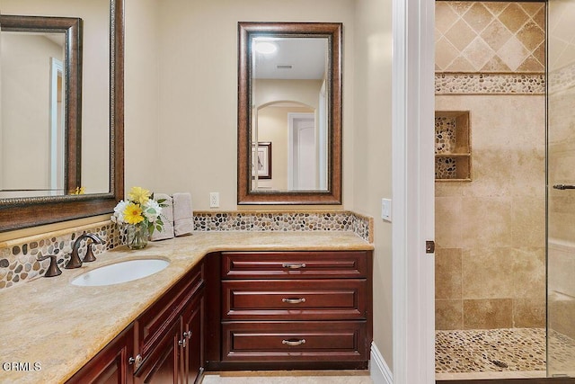 bathroom featuring vanity and a tile shower