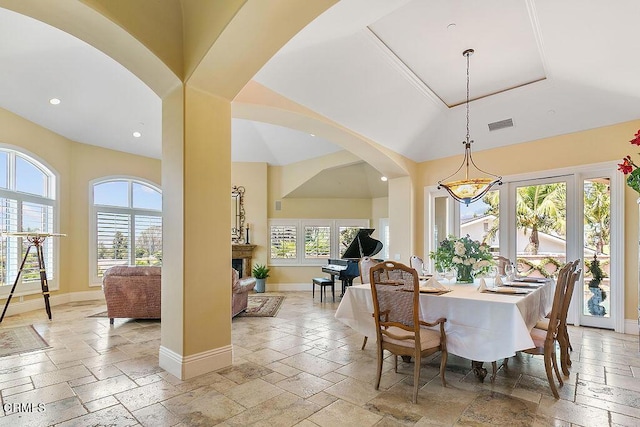 dining space with a raised ceiling and an inviting chandelier