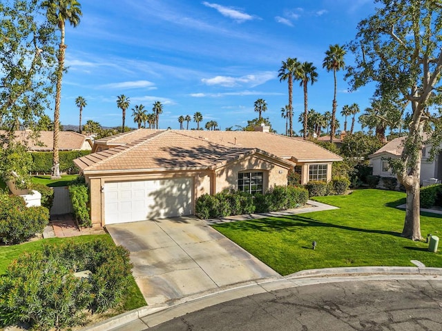 ranch-style house with a garage and a front lawn