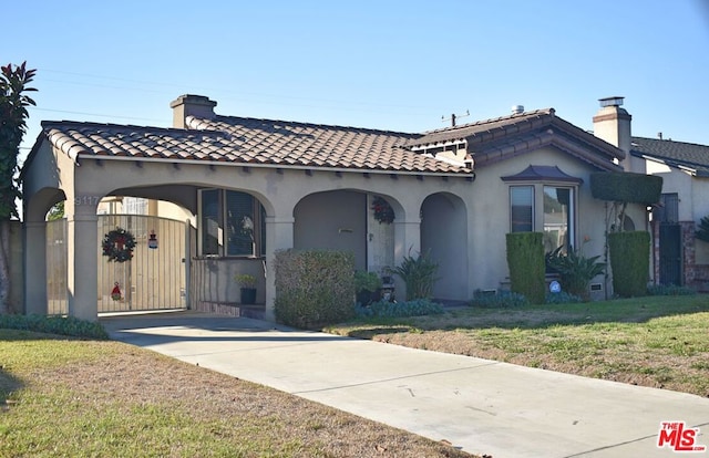 mediterranean / spanish-style home featuring a front lawn